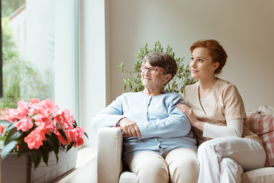 old woman and her caregiver looking outside